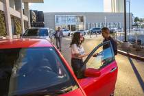 Mark Reolegio, right, valets Jennifer Sandoval's car outside The Capital Grille on Wednesday, F ...