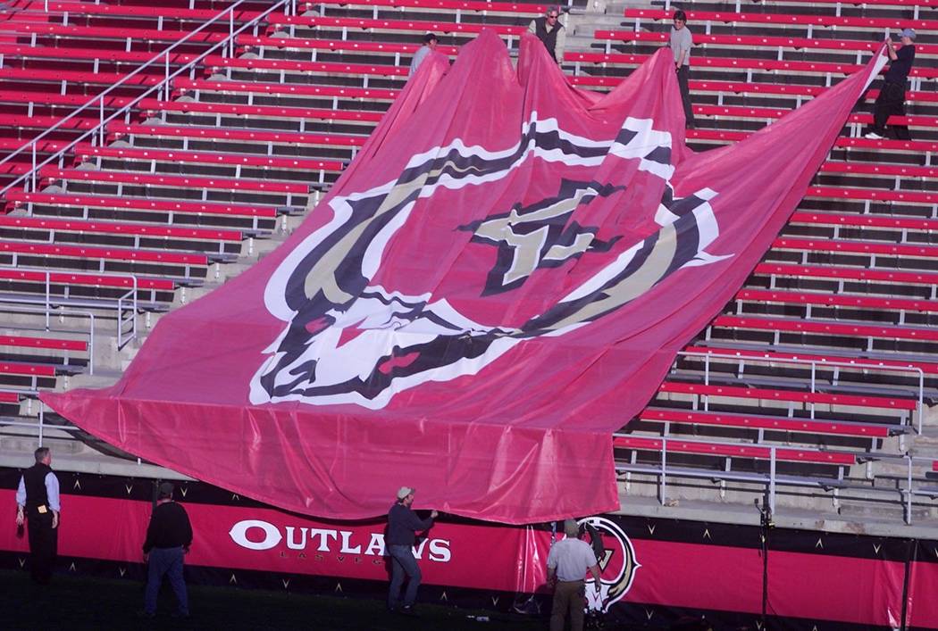 Workers at Sam Boyd Stadium pull a giant Las Vegas Outlaws logo to be placed in the the north e ...