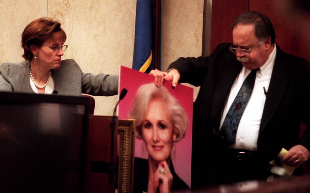 Linda Erechetta and attorney Tom Pitaro discuss blood marks while hold a portrait of Margaret R ...