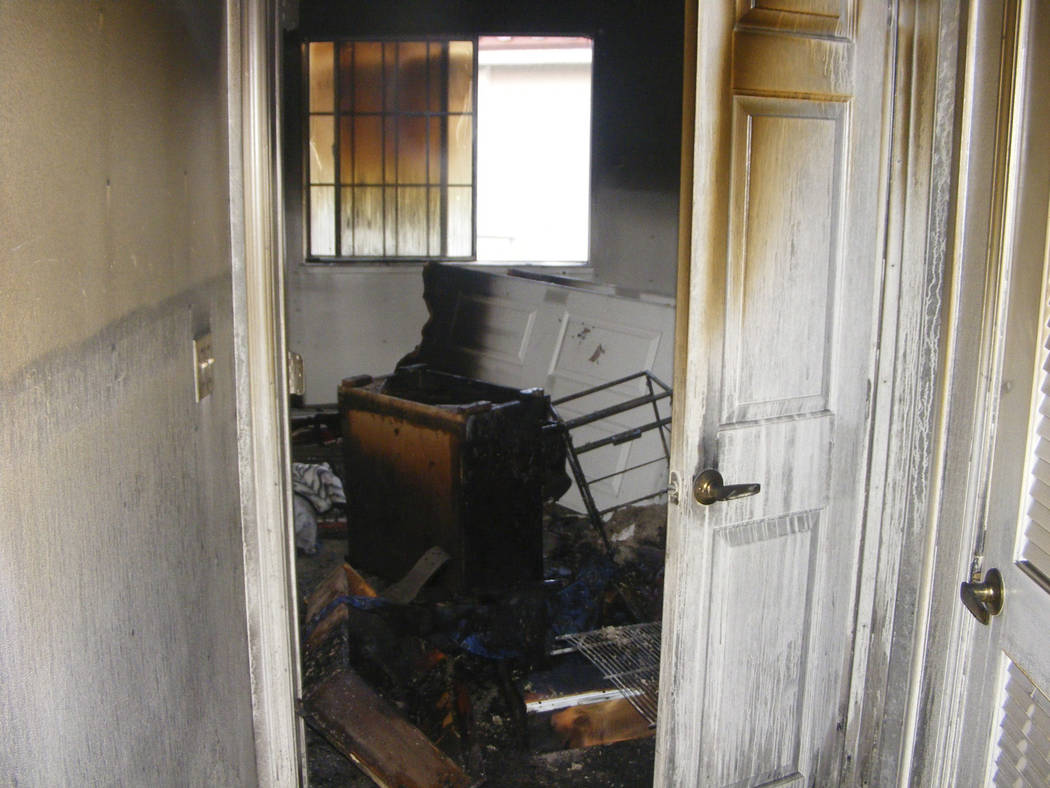 A burned-out bedroom of shootout suspect Johnny Wicks is shown in his Sunrise Village apartment ...