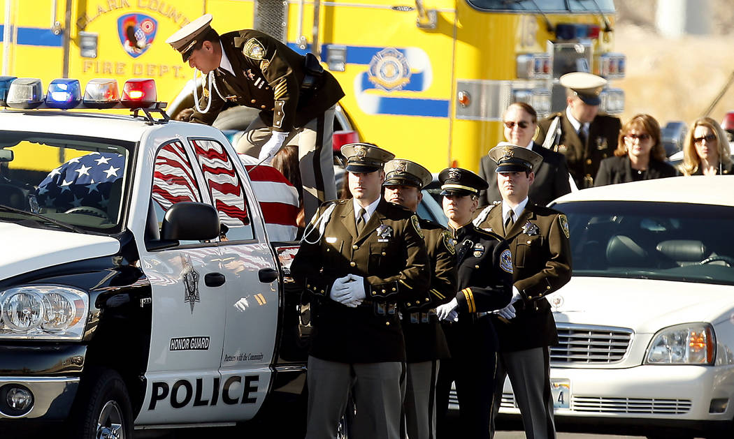 The casket of slain court security officer Stan Cooper arrives with full escort for a funeral s ...