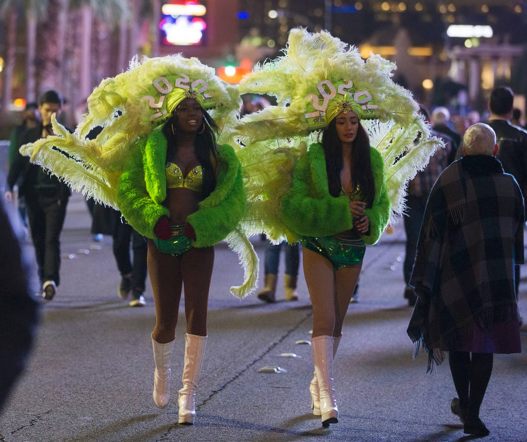 Show girls walk the Strip on Tuesday, Dec. 31, 2019, in Las Vegas. (Benjamin Hager/Las Vegas Re ...