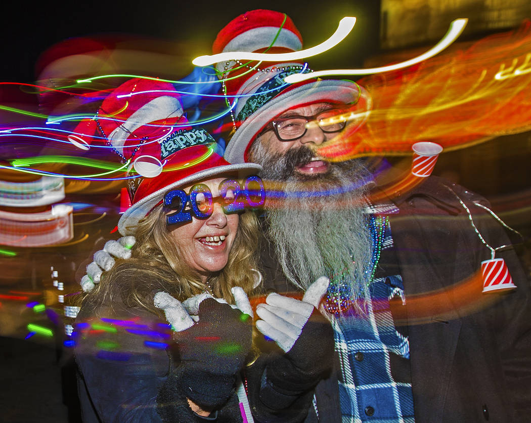 Trip, left, and Jess Barrios walk the Strip on Tuesday, Dec. 31, 2019, in Las Vegas. (Benjamin ...