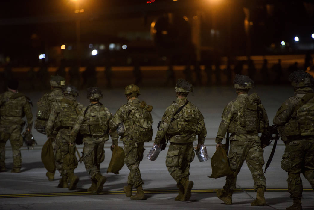 Soldiers board a C-17 aircraft Wednesday, Jan. 1, 2020 at Fort Bragg, N.C., to be deployed in I ...