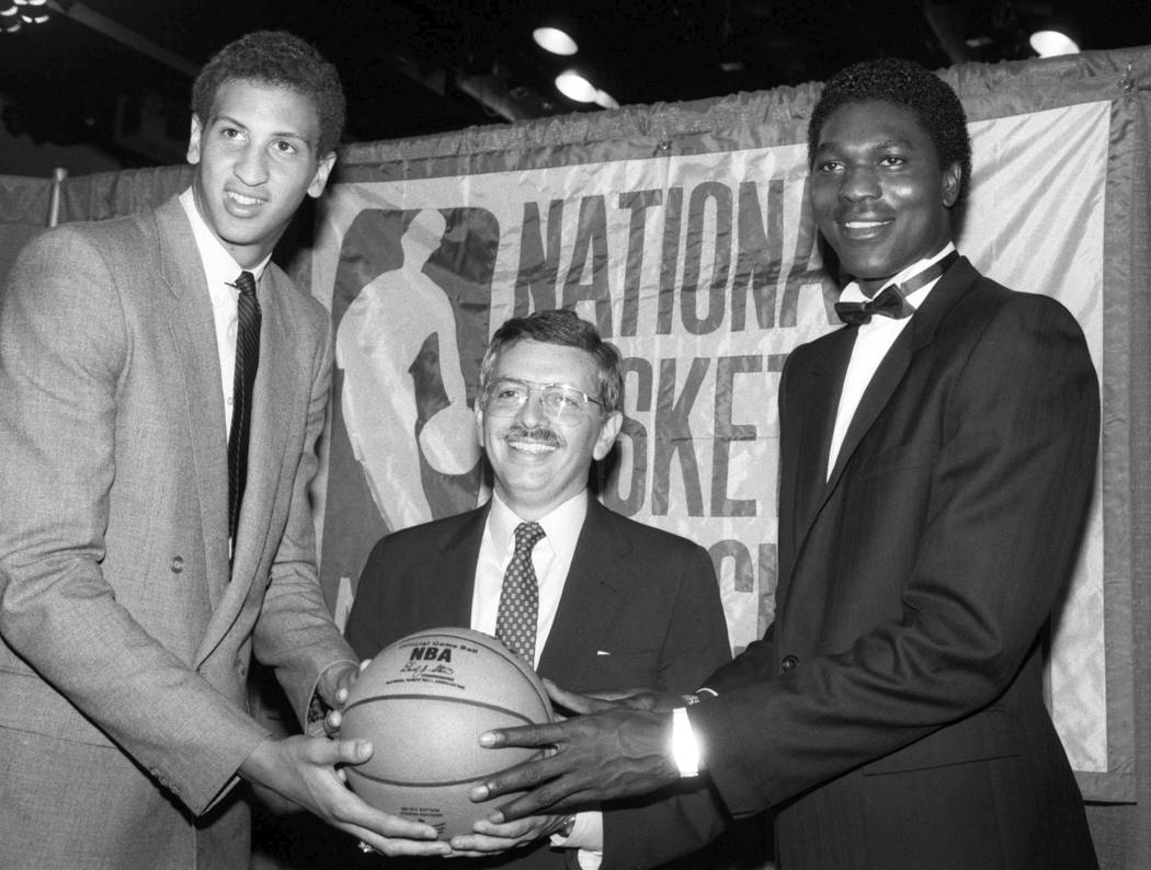 NBA commissioner David Stern, center, is flanked by Akeem Olajuwon, right, the No. 1 pick overa ...