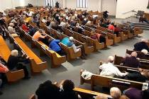 Churchgoers take cover while a congregant armed with a handgun, top left, engages a man who ope ...