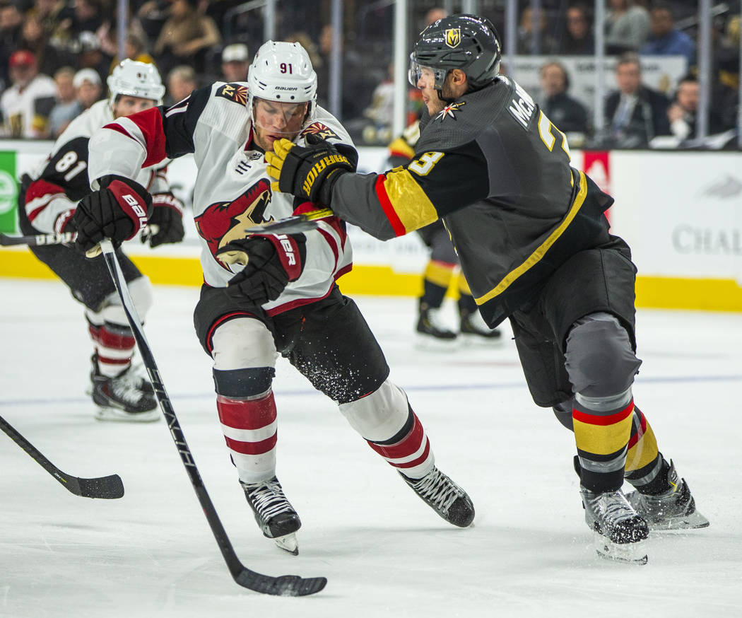 Arizona Coyotes left wing Taylor Hall (91, left) takes a shot from Vegas Golden Knights defense ...