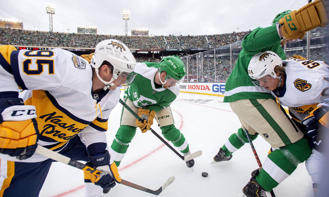 Nashville Predators' centers Matt Duchene (95) and Mikael Granlund (64) battle for the puck wit ...