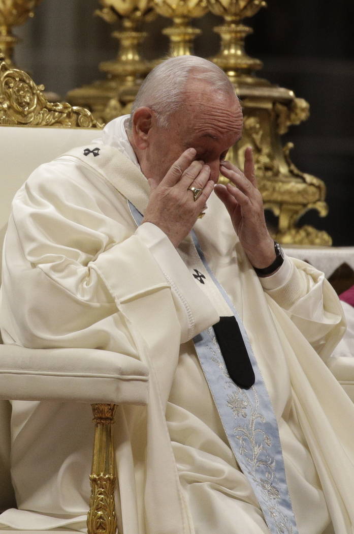 Pope Francis wipe his eyes as he presides over a Mass for the solemnity of St. Mary at the begi ...