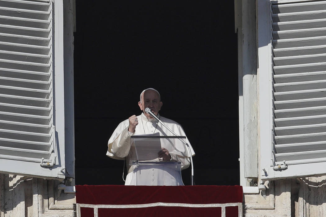 Pope Francis recites the Angelus prayer from his studio's window overlooking St. Peter's square ...