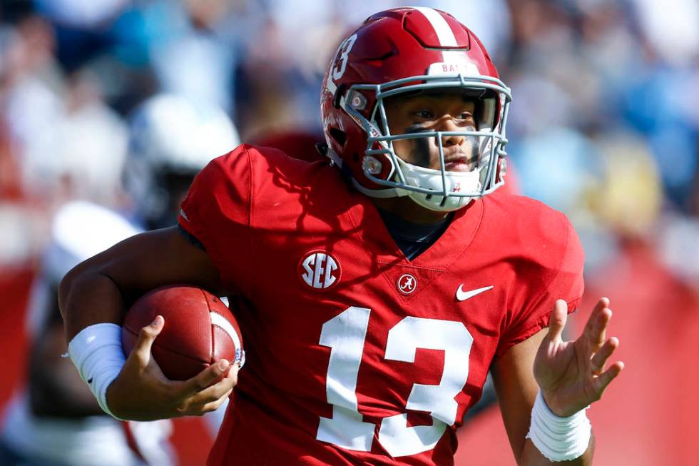 Alabama quarterback Tua Tagovailoa (13) carries the ball during the first half of an NCAA colle ...