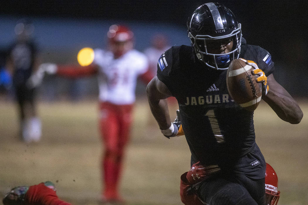 Desert Pines' Darnell Washington (1) makes way to the end zone as Arbor View's Rickie Davis Jr. ...