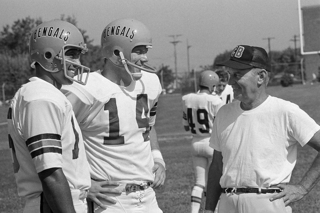 Cincinnati Bengals' head football coach Paul Brown, right, talks with two of his quarterbacks d ...