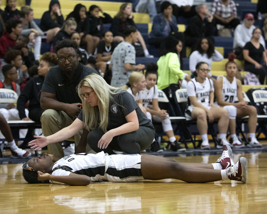 Desert Oasis's Jordyn Stroud (12) lies on the ground after being hit in the face during the gam ...