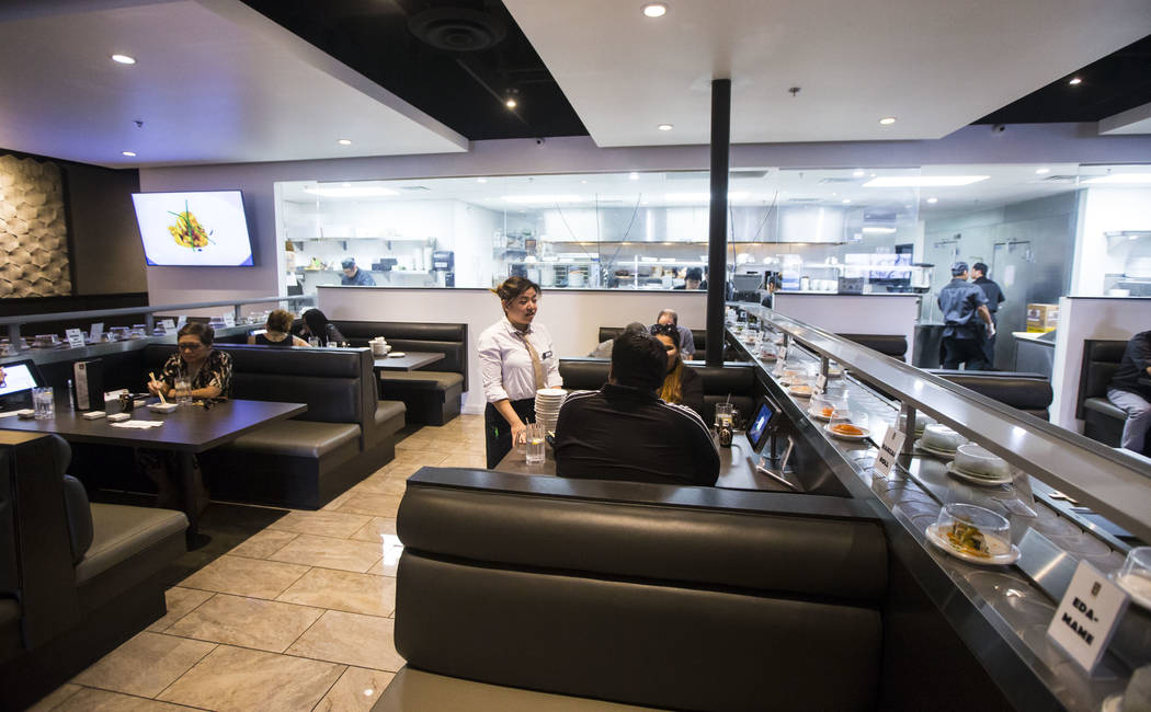 Fae Domingo, center, assists diners at Sapporo Revolving Sushi in Las Vegas on Wednesday, April ...