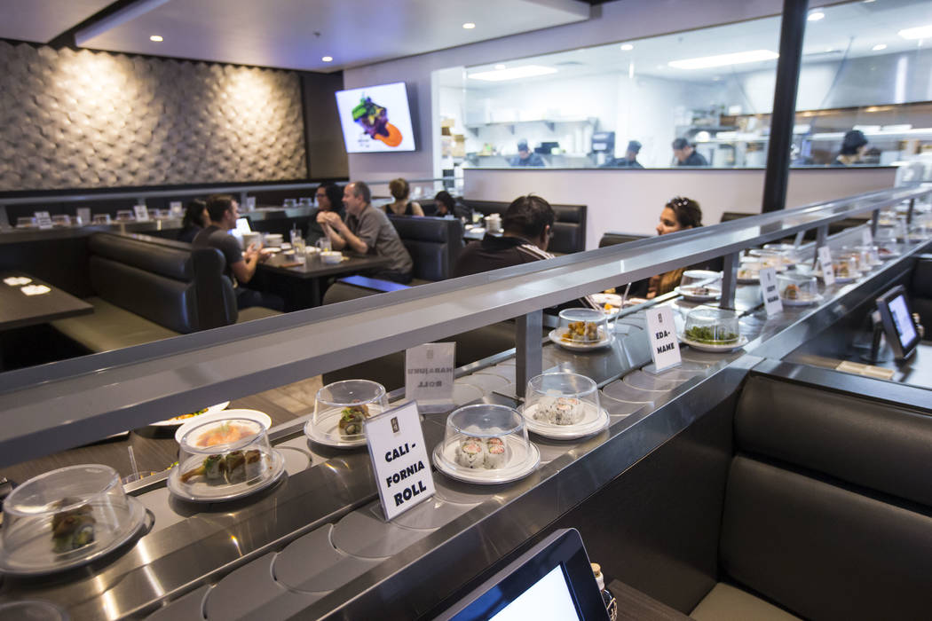 California rolls pass by on the conveyor belt at Sapporo Revolving Sushi in Las Vegas on Wednes ...