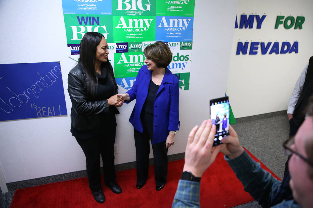 Democratic presidential candidate Amy Klobuchar, right, meets Ann Barlow, chair for the Nationa ...
