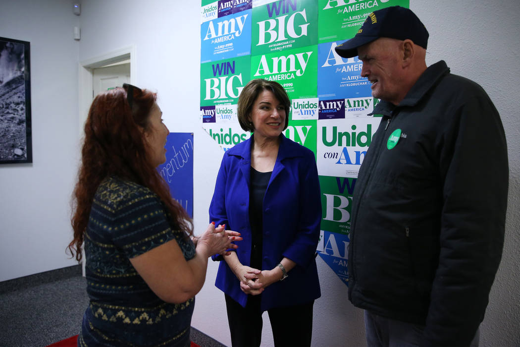 Democratic presidential candidate Amy Klobuchar, center, meets supporters Diane Via, left, and ...