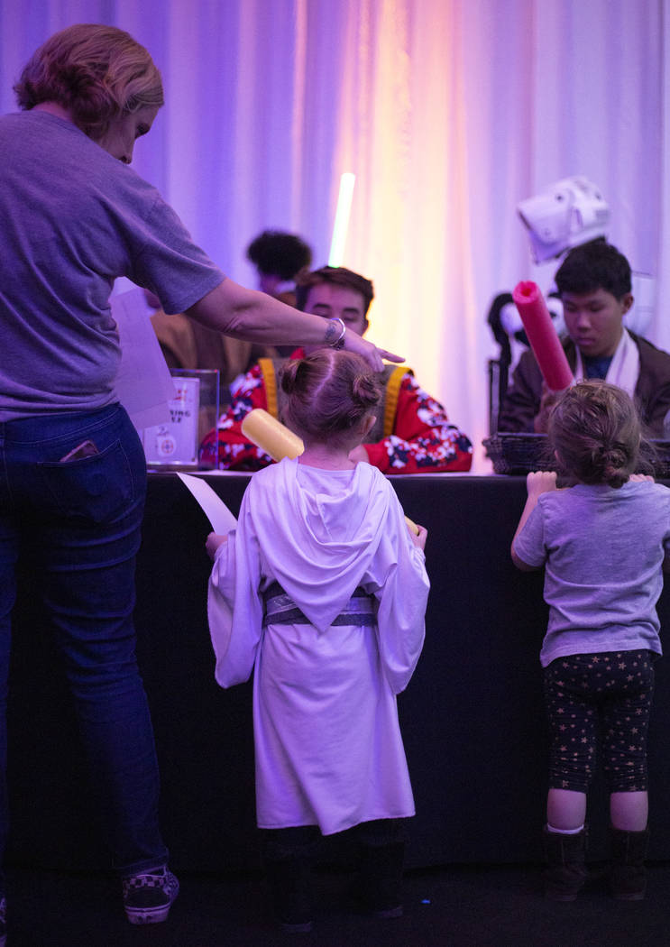 Little ones wait in line to color their own light saber handle at the Galaxy Gathering at Oppor ...