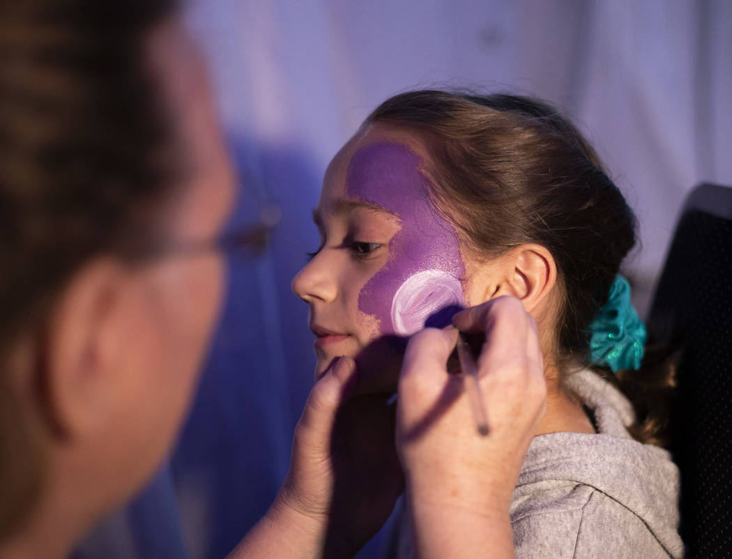 Eisley Barber, 8, has a Death Star painted on her face at the Galaxy Gathering at Opportunity V ...