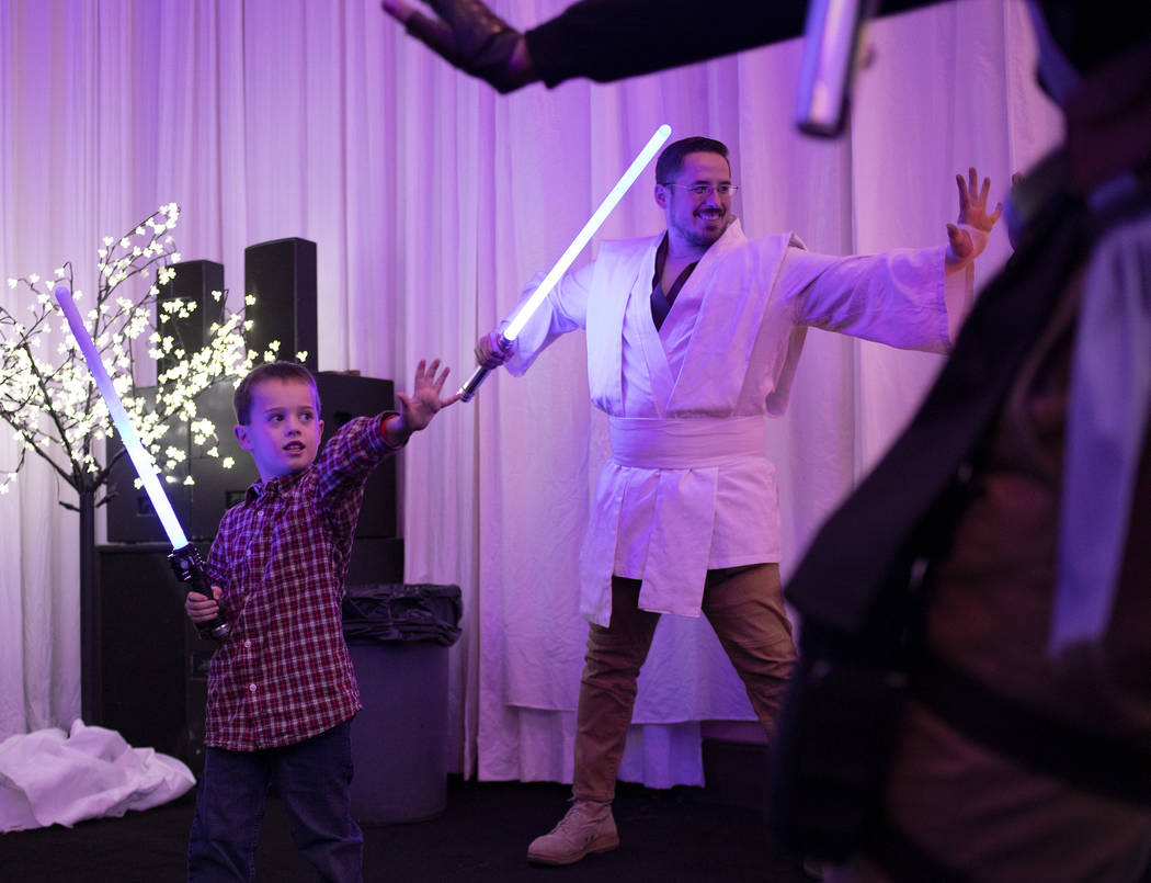 Ryan Fenno, 6, duels with members of the Society of Light Saber Duelists UNLV at the Galaxy Gat ...