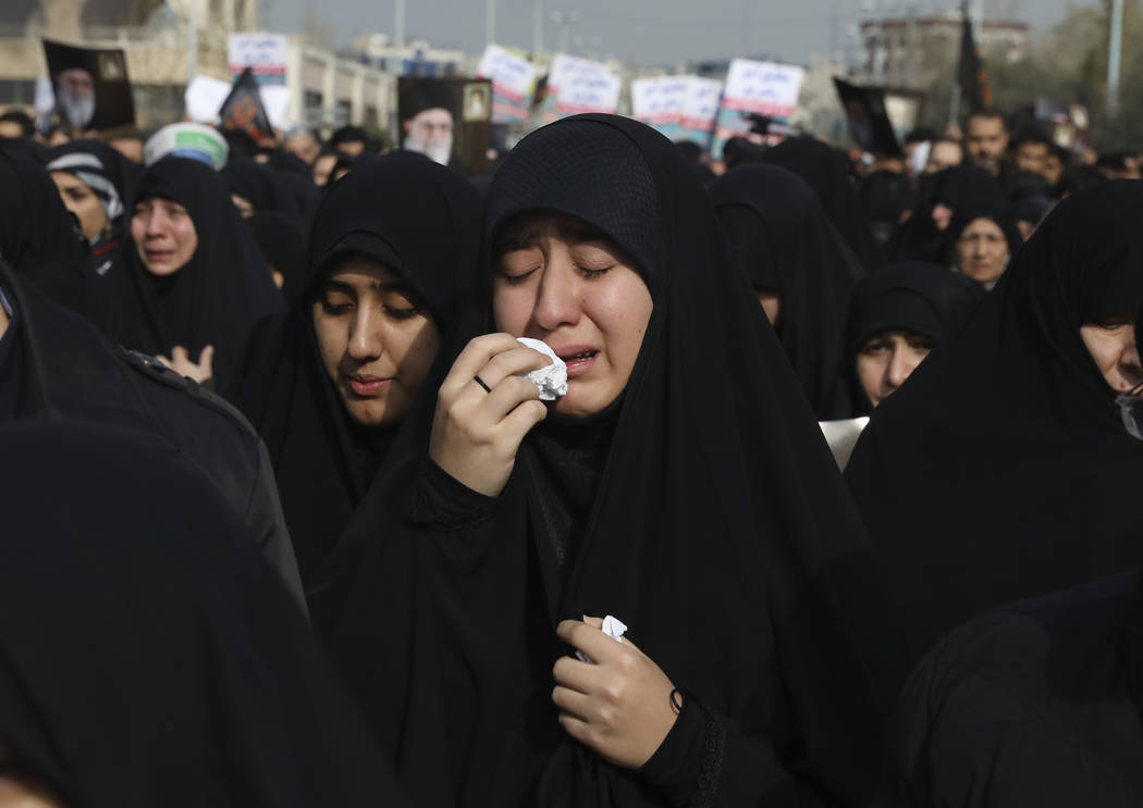 A women weeps while mourning during a demonstration over the U.S. airstrike in Iraq that killed ...