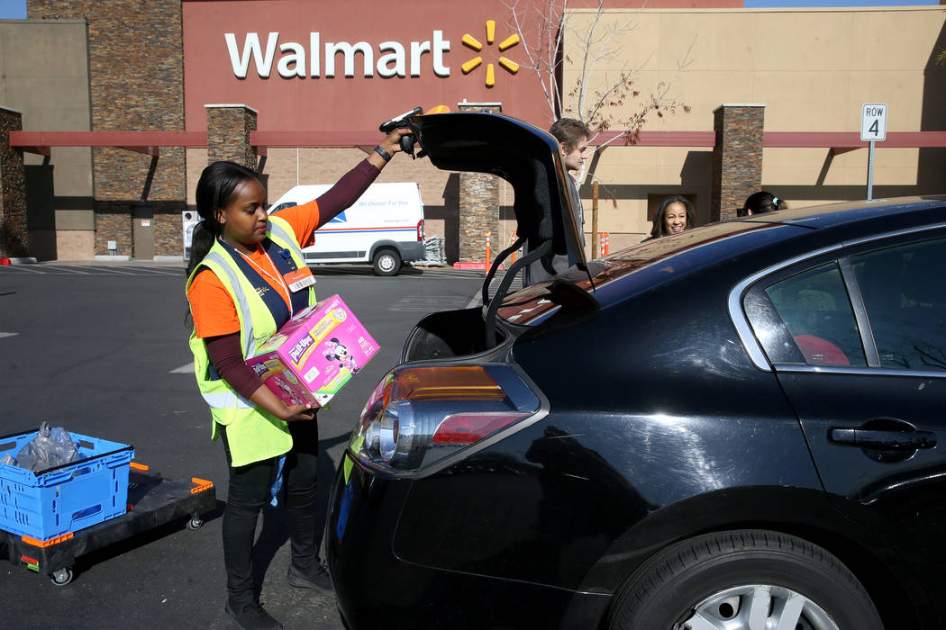 Personal shopper Mety Woldeyes loads a customer’s curbside pickup order