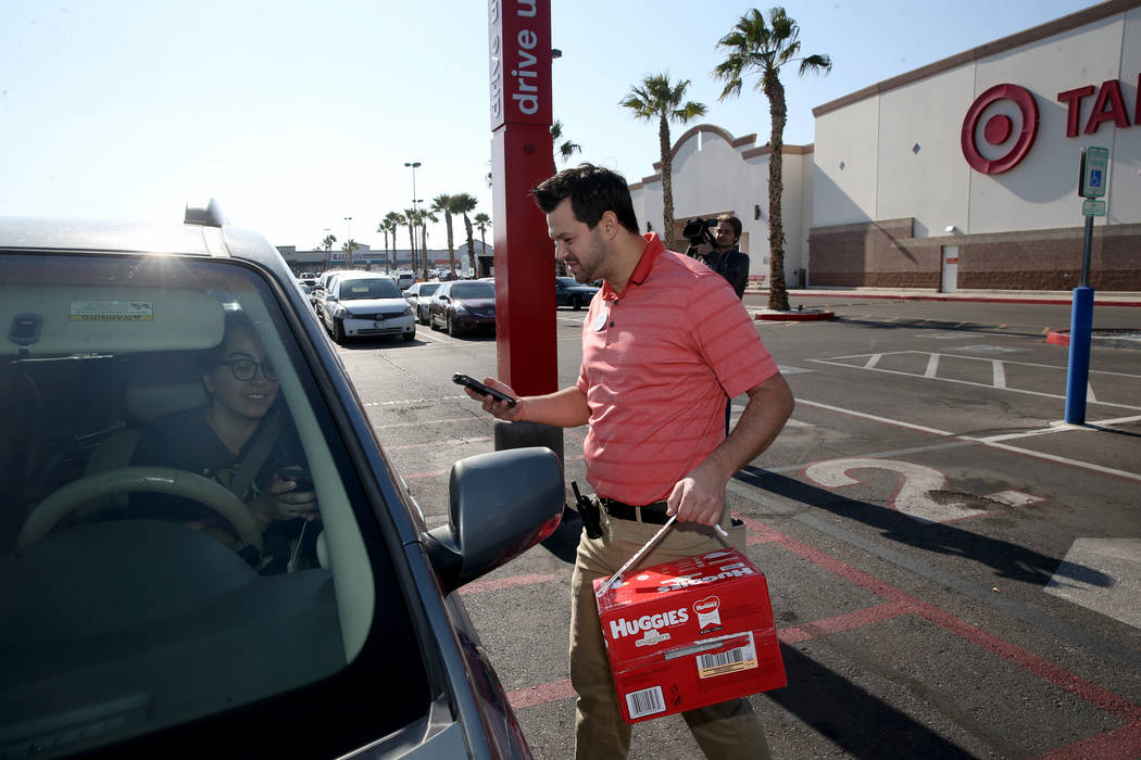 Greg Latter, a service and engagement executive, delivers delivers a curbside pickup order to C ...