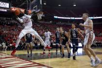 UNLV's forward Mbacke Diong (34) grabs the ball on defense as Utah State players look on during ...