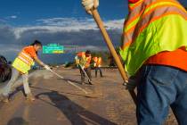 A Nevada Department of Transportation crew works to clear the roadway at the I-215 eastbound of ...