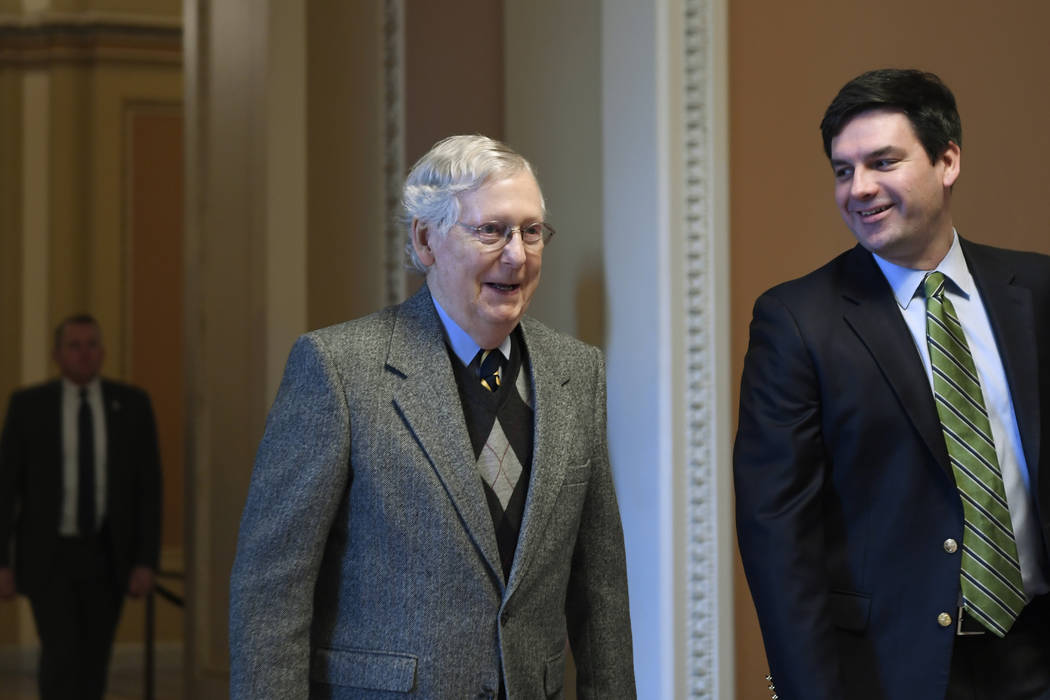 Senate Majority Leader Mitch McConnell of Ky., arrives on Capitol Hill in Washington, Friday, J ...
