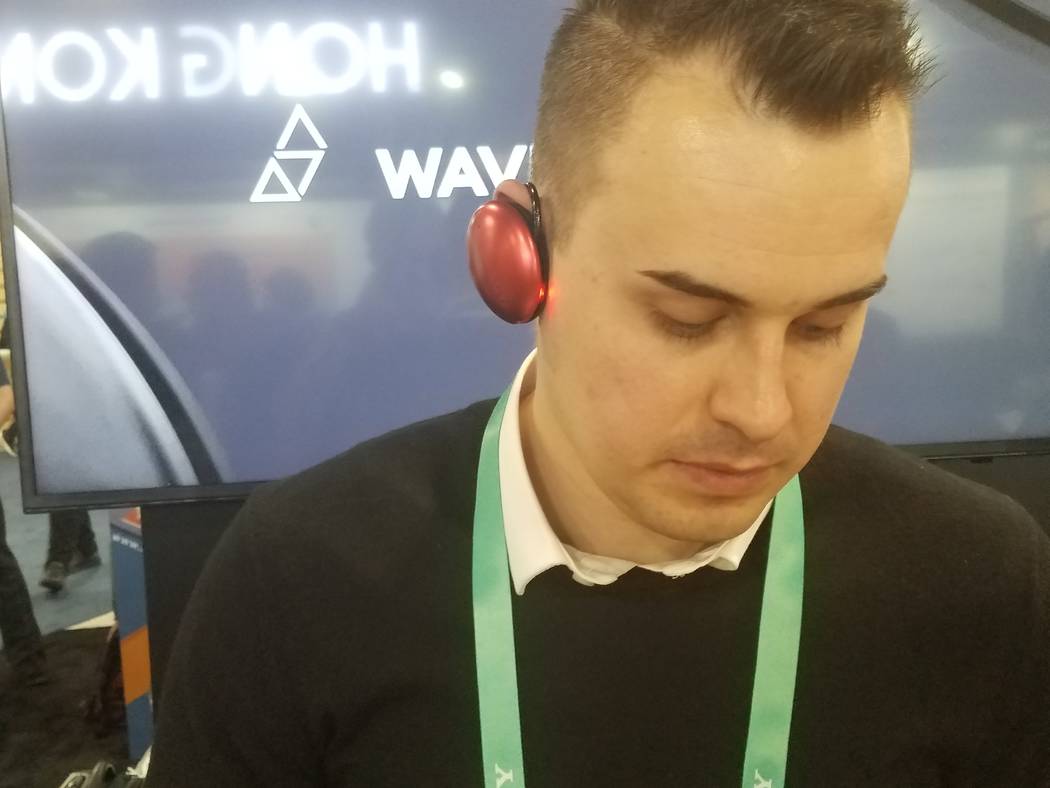 Georgiy Konovalov of Brooklyn, New York-based Waverly Labs, wears an Ambassador Interpreter spe ...