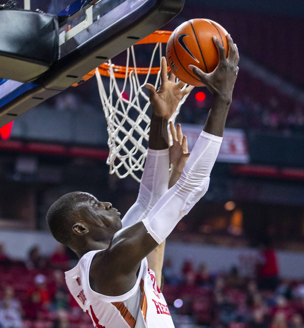 UNLV Rebels forward Cheickna Dembele (15) gets off a shot under the rim over Air Force Falcons ...