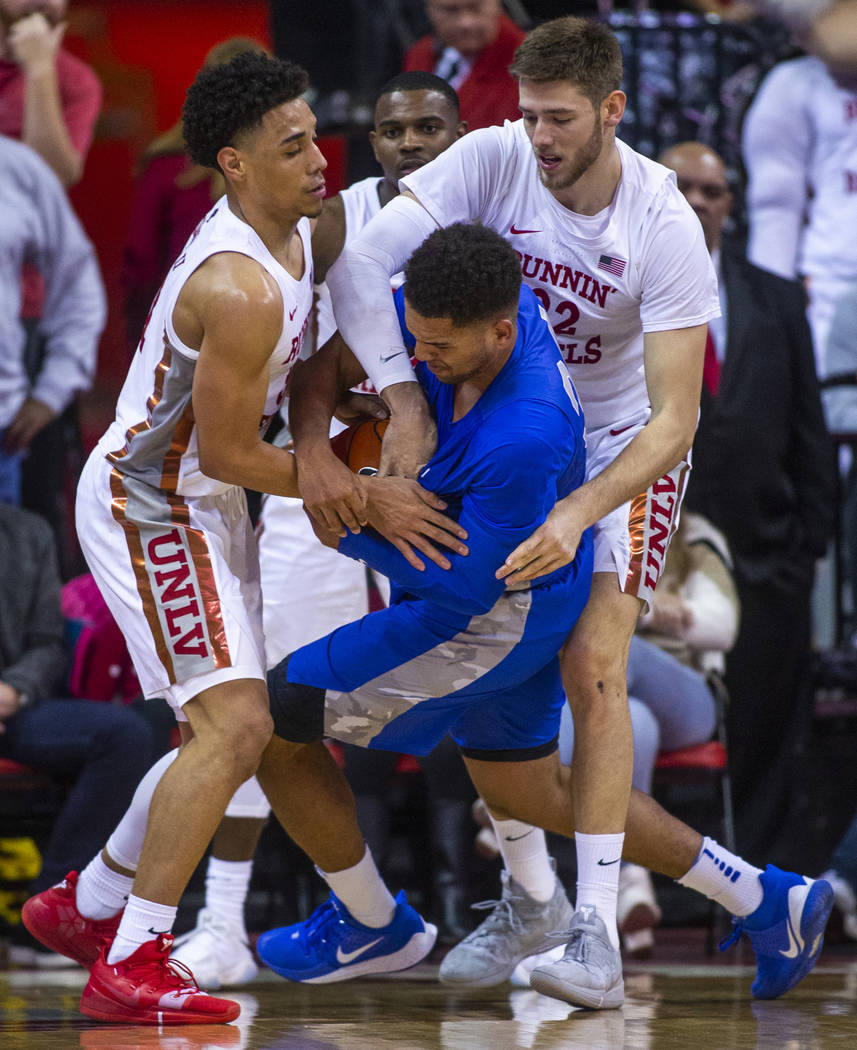 UNLV Rebels guard Marvin Coleman (31, left) and teammate forward Vitaliy Shibel (22, right) att ...