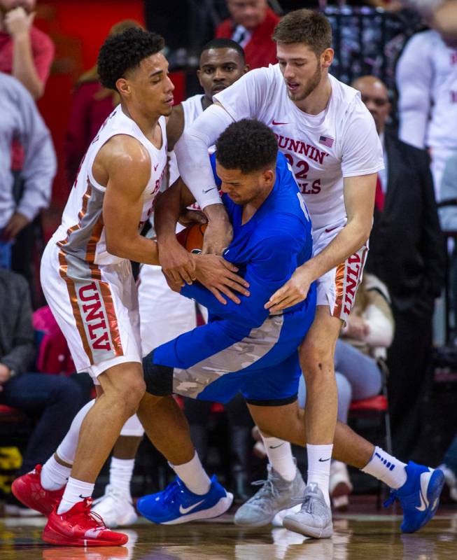 UNLV Rebels guard Marvin Coleman (31, left) and teammate forward Vitaliy Shibel (22, right) att ...