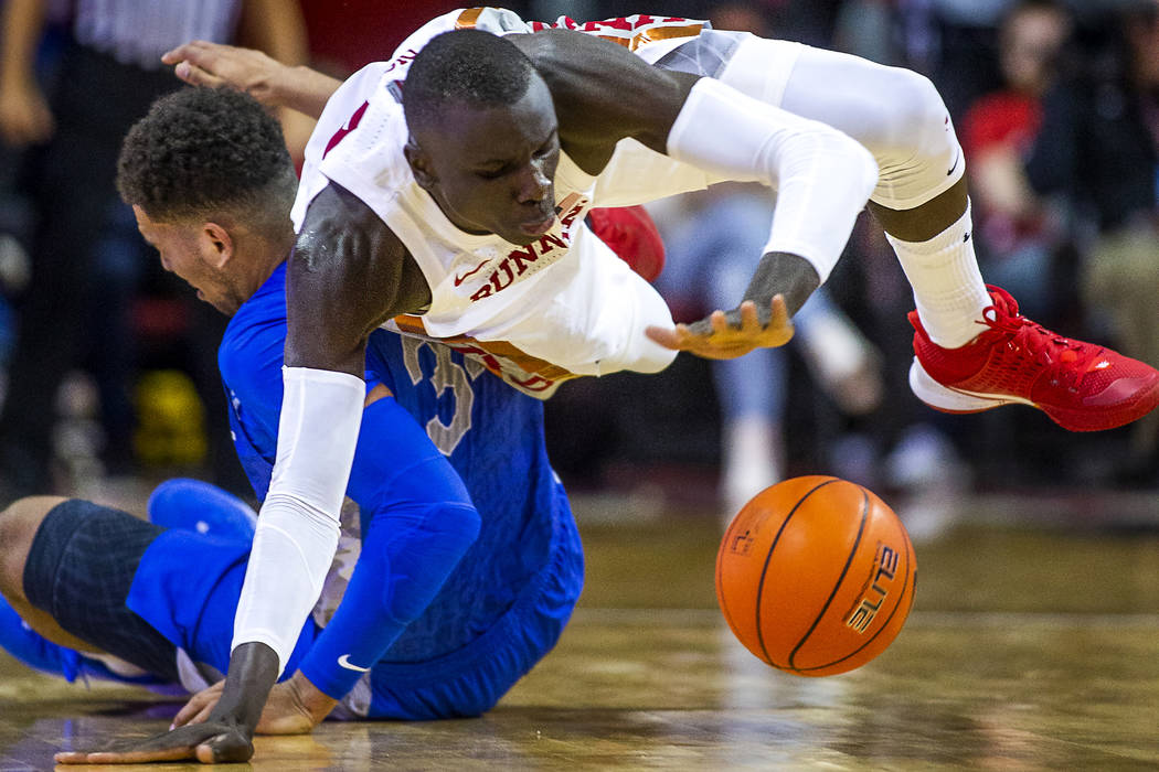 UNLV Rebels forward Cheikh Mbacke Diong (34) goes to the floor to steal the ball from Air Force ...