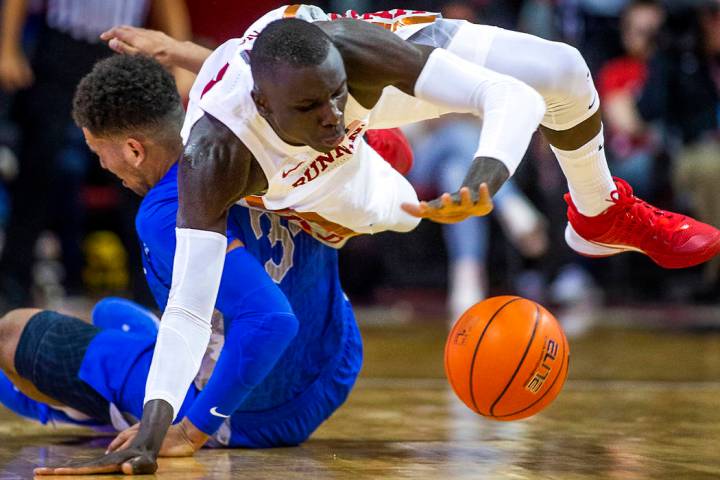 UNLV Rebels forward Cheikh Mbacke Diong (34) goes to the floor to steal the ball from Air Force ...