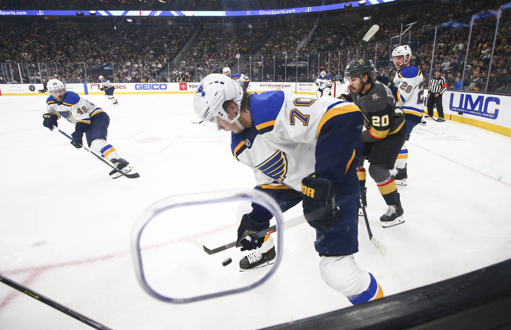 St. Louis Blues' Oskar Sundqvist (70) moves the puck in front of Golden Knights' Chandler Steph ...