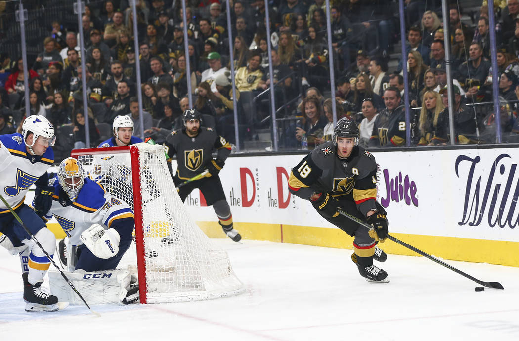Golden Knights' Reilly Smith (19) moves the puck as St. Louis Blues goaltender Jake Allen (34) ...