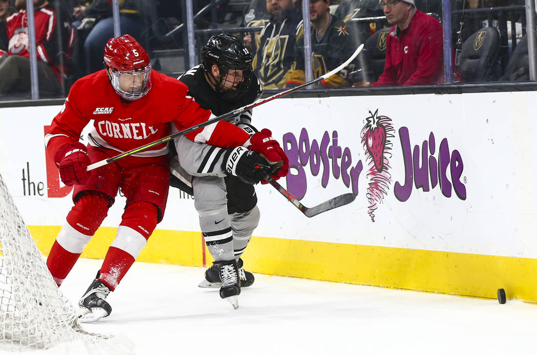 Cornell Big Red's Sebastian Dirven (5) and Providence Friars' Jack Dugan (12) battle for the pu ...