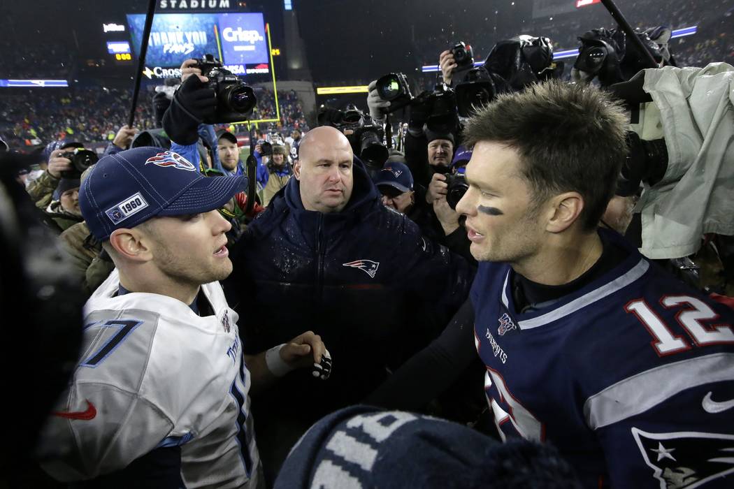 Tennessee Titans quarterback Ryan Tannehill, left, and New England Patriots quarterback Tom Bra ...