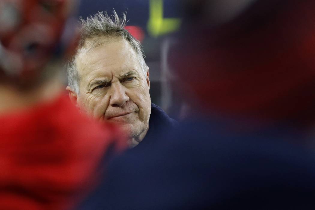 New England Patriots head coach Bill Belichick watches the final minute of an NFL wild-card pla ...
