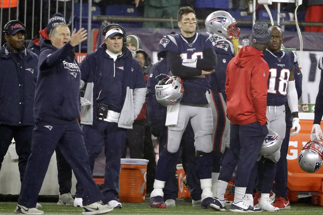 New England Patriots head coach Bill Belichick, left, offensive coordinator Josh McDaniels, cen ...