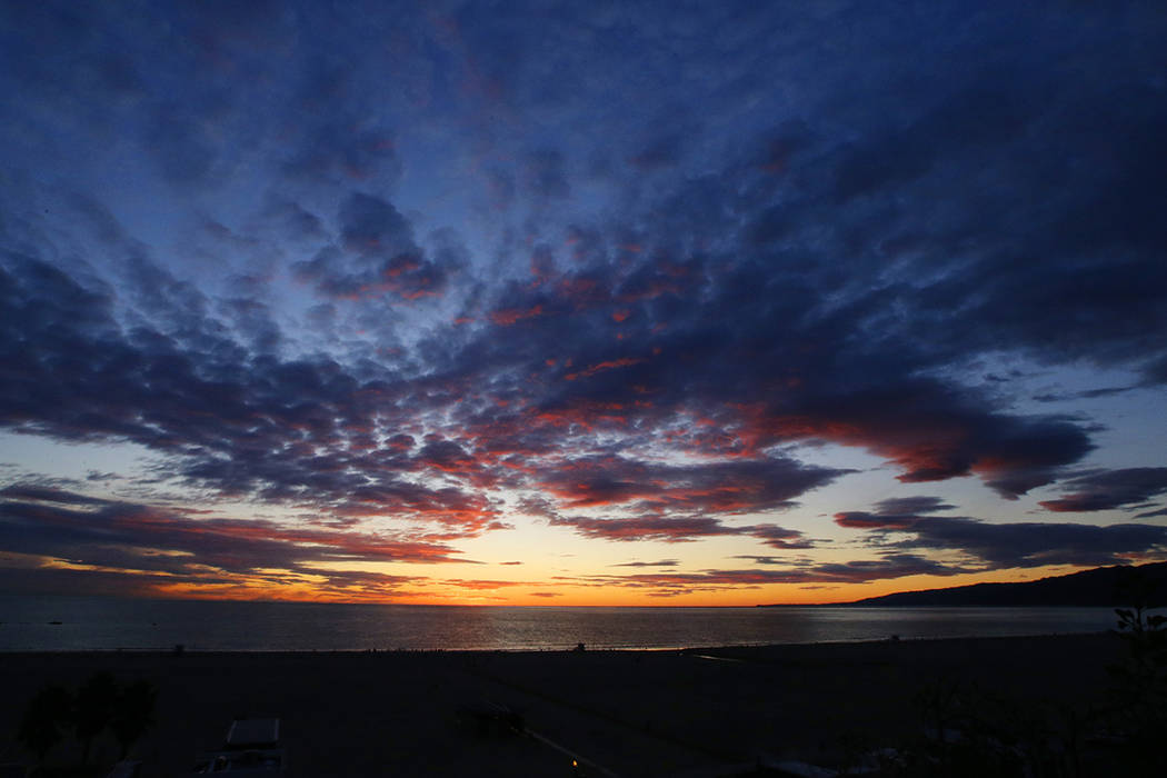 The sun sets over the Pacific Ocean as the most recent in a series of storms passes through Sou ...