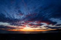 The sun sets over the Pacific Ocean as the most recent in a series of storms passes through Sou ...