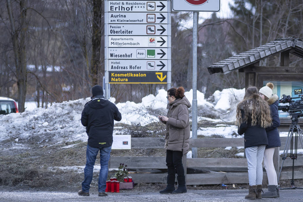 People gather near candle at the scene where a car had plowed into a group of people in Luttach ...