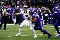 New Orleans Saints quarterback Drew Brees (9) fumbles as he is hit by Minnesota Vikings defensi ...