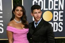 Priyanka Chopra, left, and Nick Jonas arrive at the 77th annual Golden Globe Awards at the Beve ...