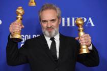 Sam Mendes poses in the press room with the awards for best director, motion picture and best m ...