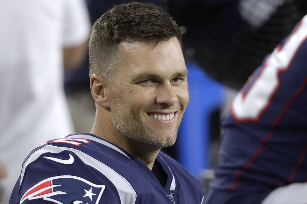 New England Patriots quarterback Tom Brady sits on the bench in